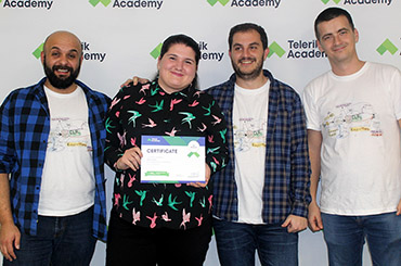 A Telerik Academy graduate posing with her diploma in the company of her trainers