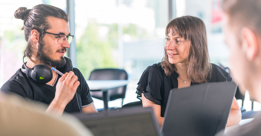 Two Telerik Academy students discussing a task during classes