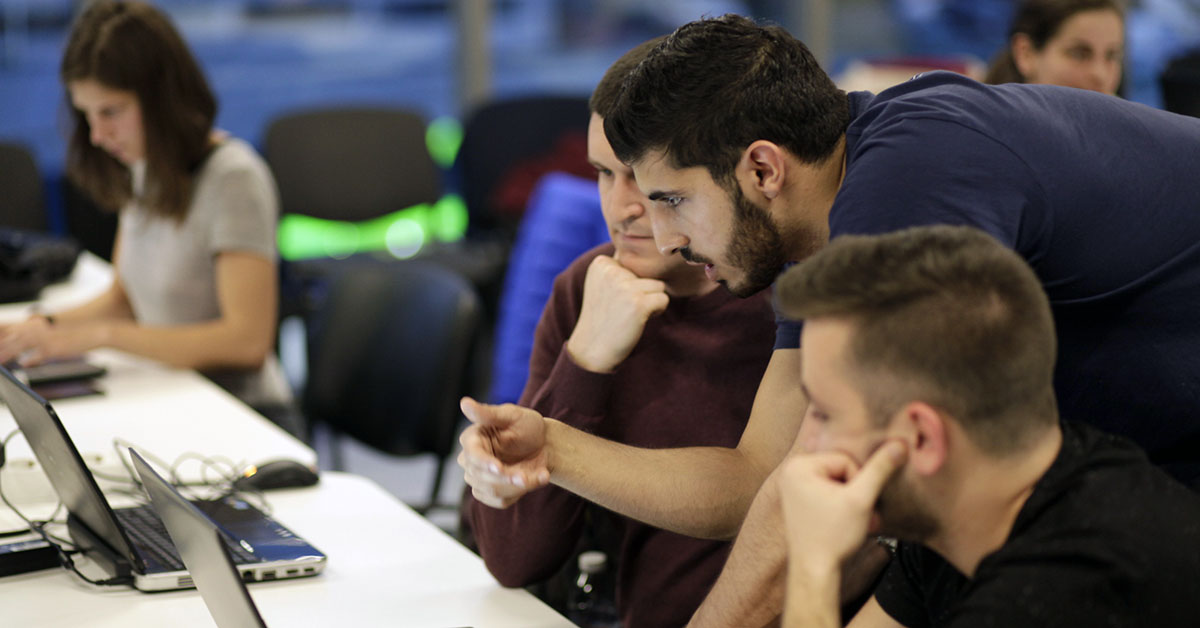 Students in front of a computer learning to code at telerik academy